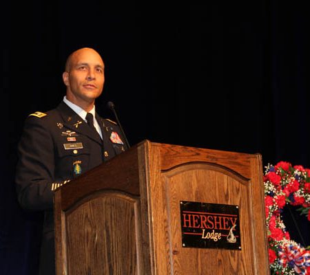 a person in military uniform standing at a podium