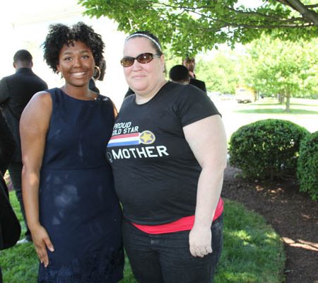 a couple of women standing together
