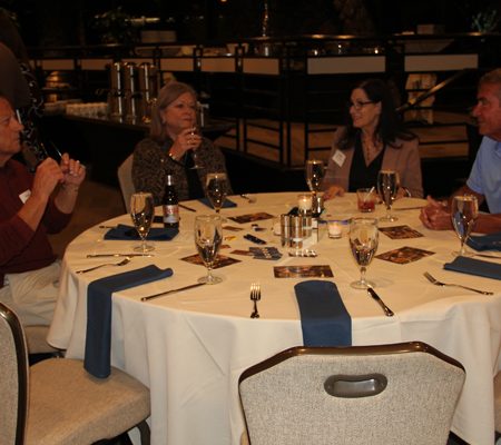 a group of people sitting at a round table