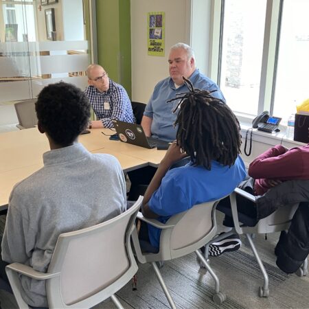 a group of people sitting around a table