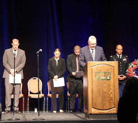 a group of people standing at a podium