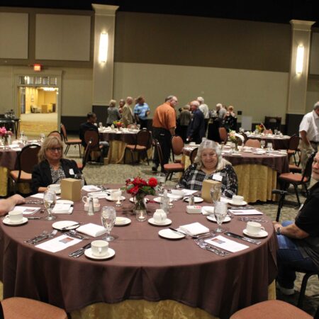 a group of people sitting at a round table