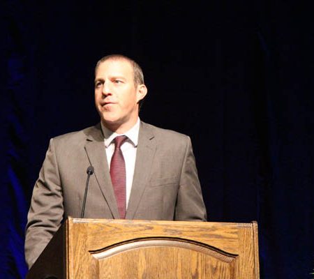 a person standing at a podium