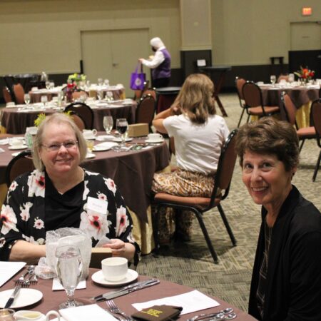 a group of women sitting at tables