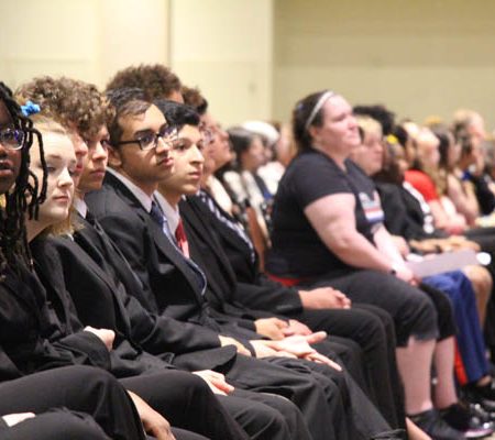 a group of people sitting in a row