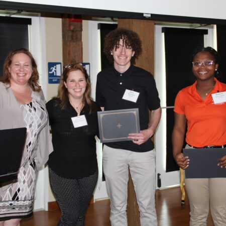 a group of people holding laptops
