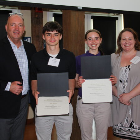 a group of people holding certificates