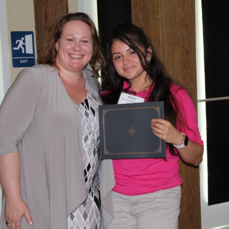 a person holding a plaque with a child