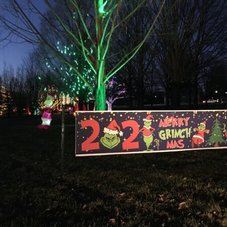 a sign with numbers and trees in the background