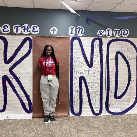 a person standing in front of a sign