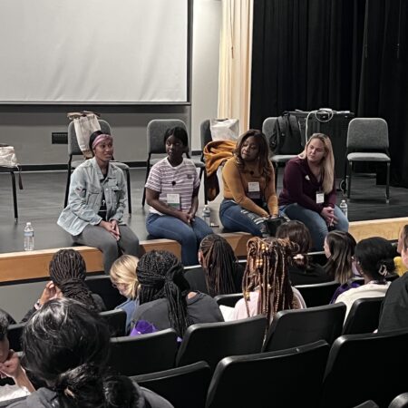 a group of people sitting on a stage