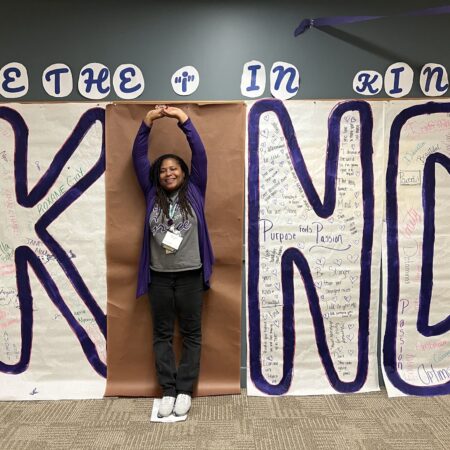 a person standing in front of a sign