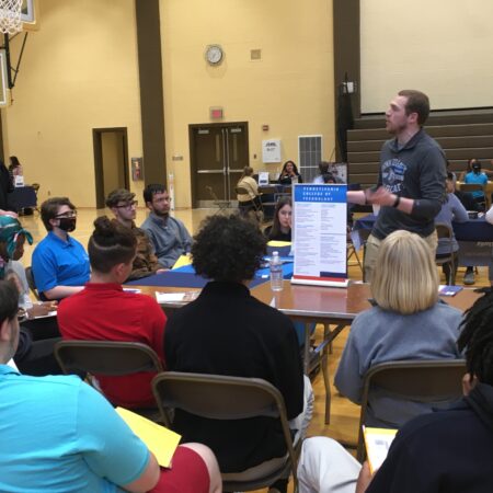 a person standing in front of a group of people