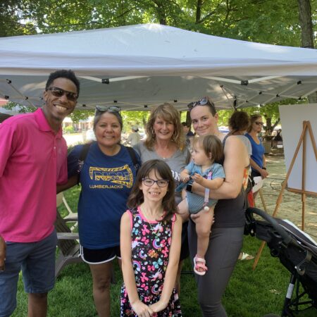 a group of people standing under a tent