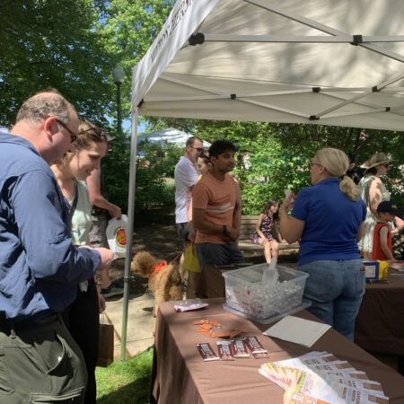 a group of people standing around a table