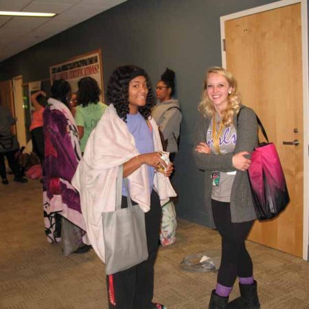 a group of women standing in a hallway
