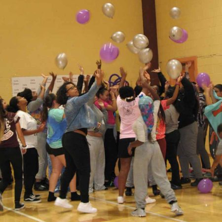 a group of people throwing balloons
