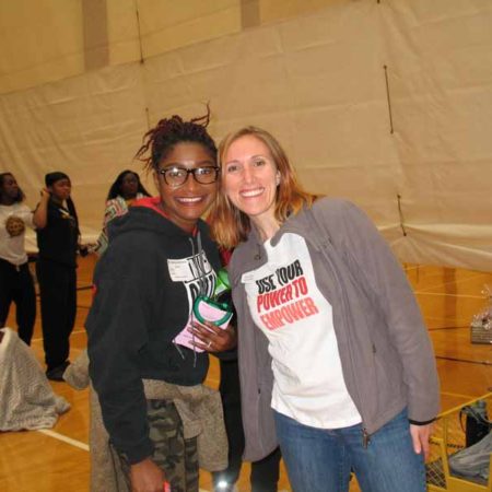 a couple of women standing together