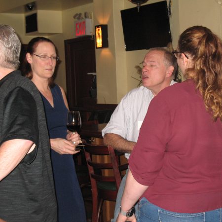 a group of people standing around each other