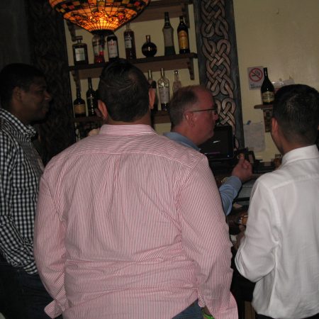 a group of men standing in a bar