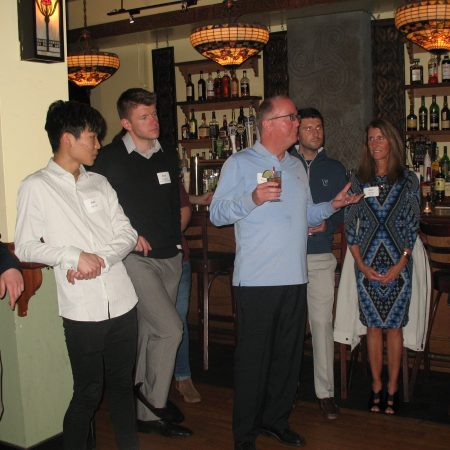 a group of people standing in a bar