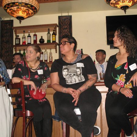 a group of people sitting at a bar
