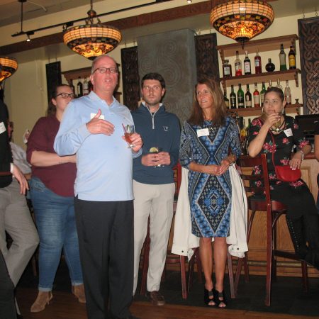 a group of people standing in a bar
