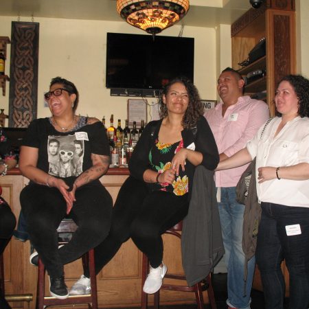 a group of people sitting at a bar