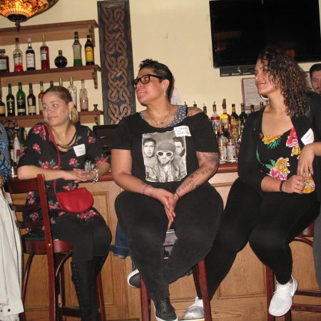 a group of people sitting at a bar
