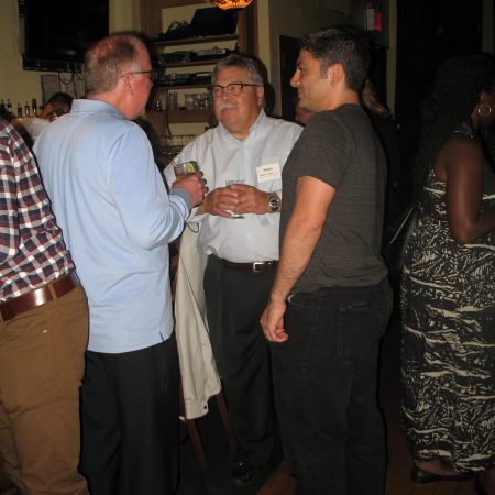 a group of men talking in a room