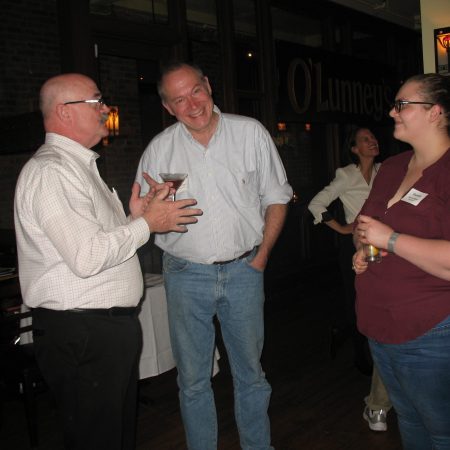 a group of people talking and drinking