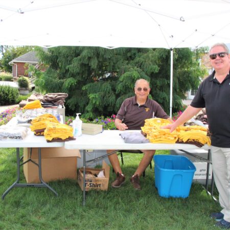 a couple of people standing under a tent