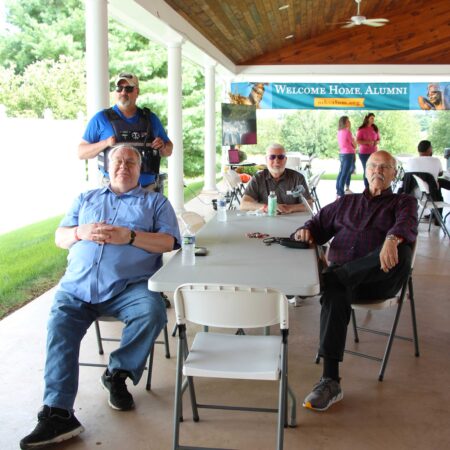 a group of men sitting at a table