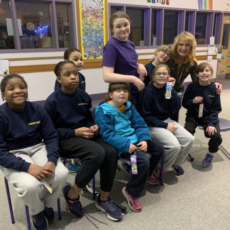 a group of children sitting on chairs