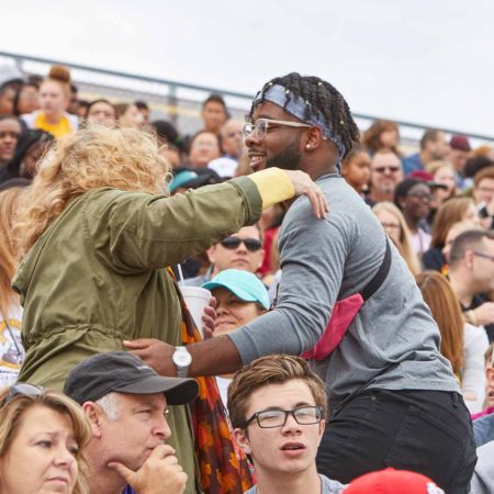 a person hugging another person in a crowd