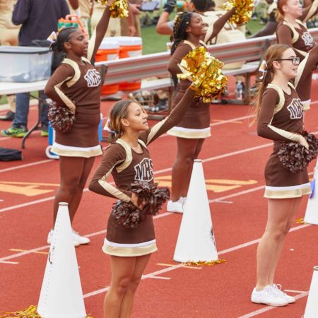 a group of cheerleaders on a track
