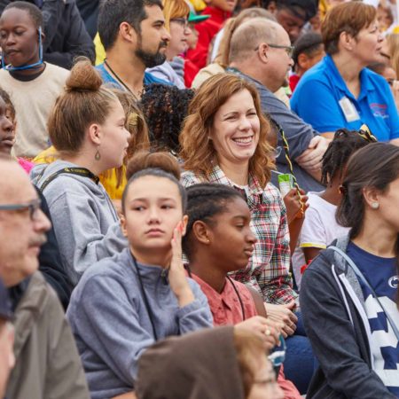 a group of people sitting in a crowd