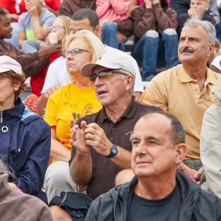 a group of people sitting in a stadium