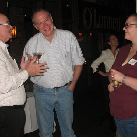 a group of people talking and drinking