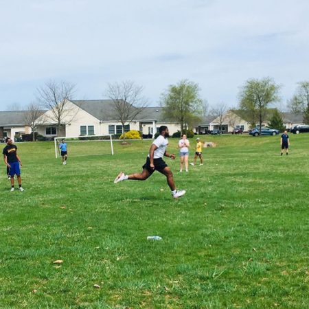 a group of people running on a field