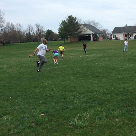 a group of people playing in a field