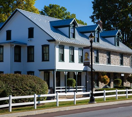 a white house with a white fence