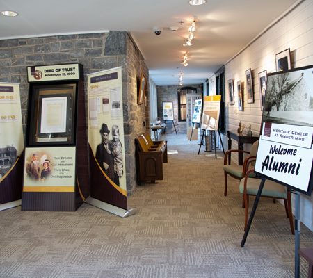 a hallway with a sign and chairs