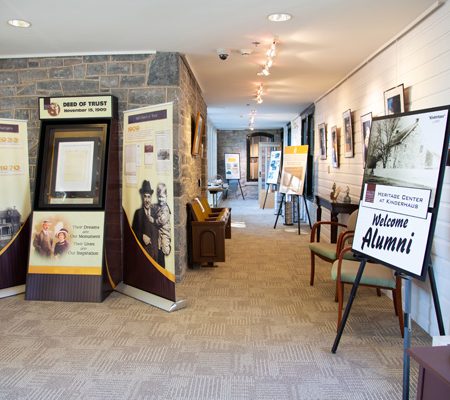a hallway with a stone wall and a sign