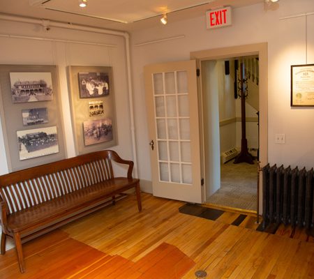a room with a wood bench and a door