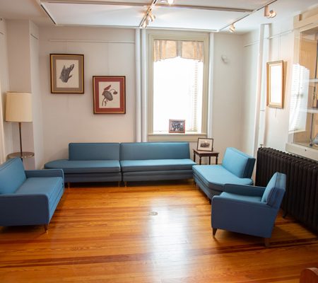 a room with blue couches and a wood floor