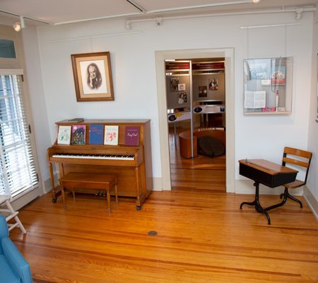 a room with a piano and a wood floor