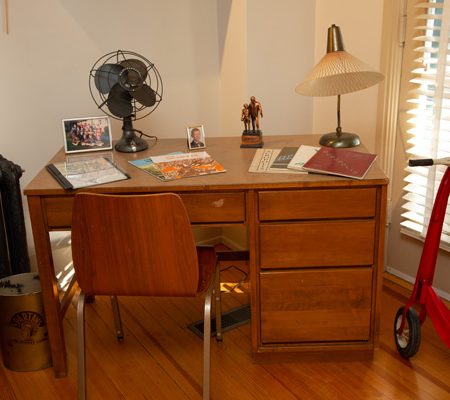 a desk with a fan and a lamp on it