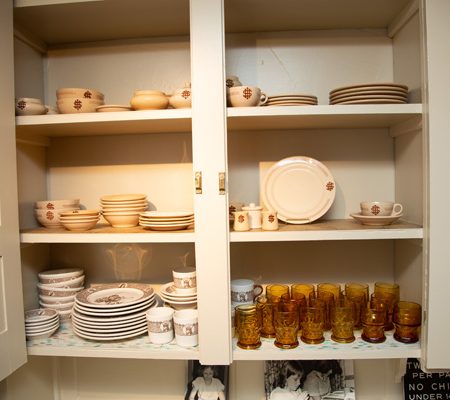 a shelf with plates and cups