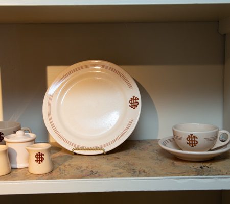a white plate and a cup on a shelf
